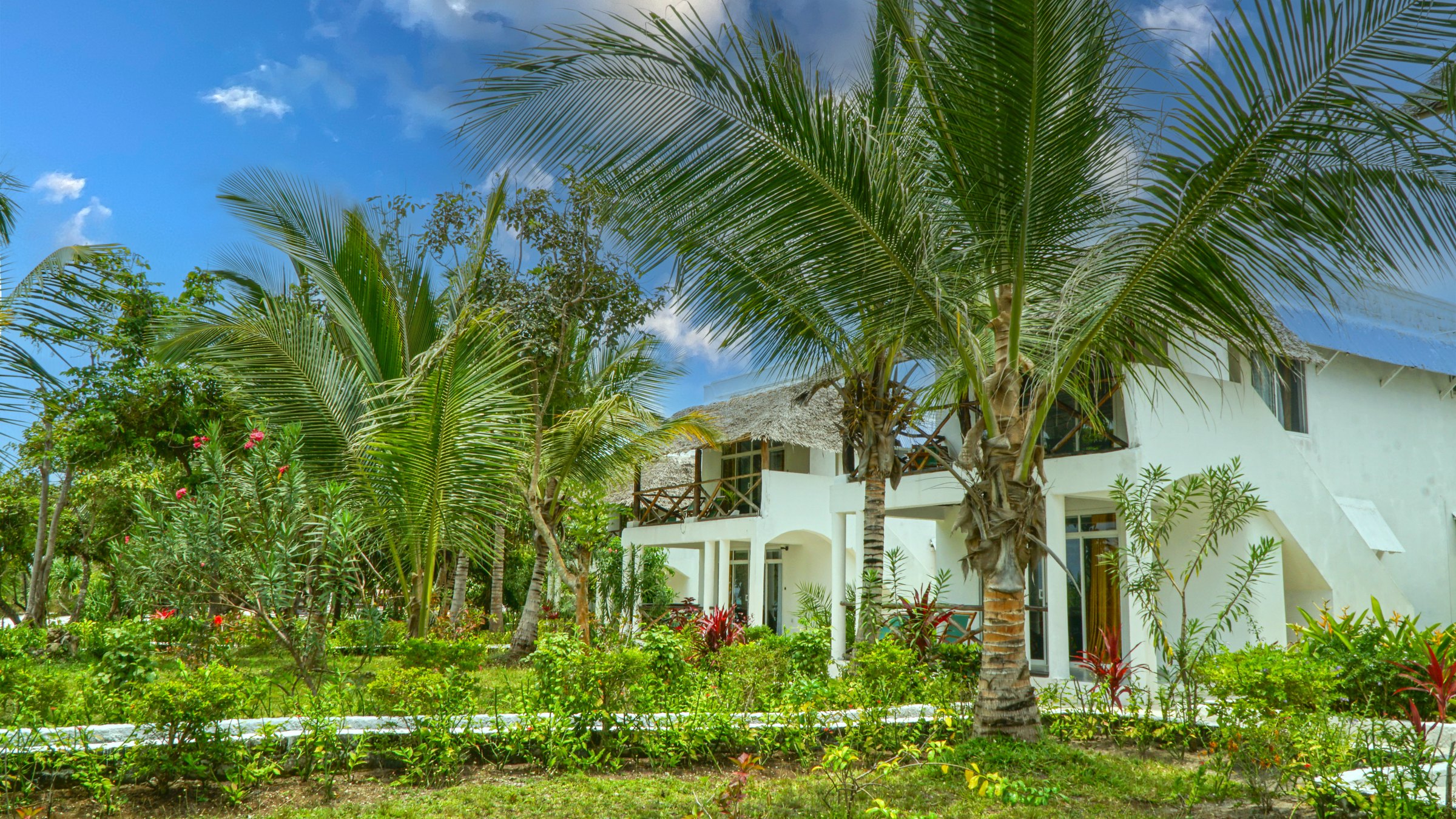 Pemba Paradise Beach Resort — a white villa among palm gardens on Pemba Island