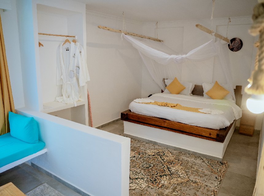 Bright modern standard room with a mosquito net and walk-in shower